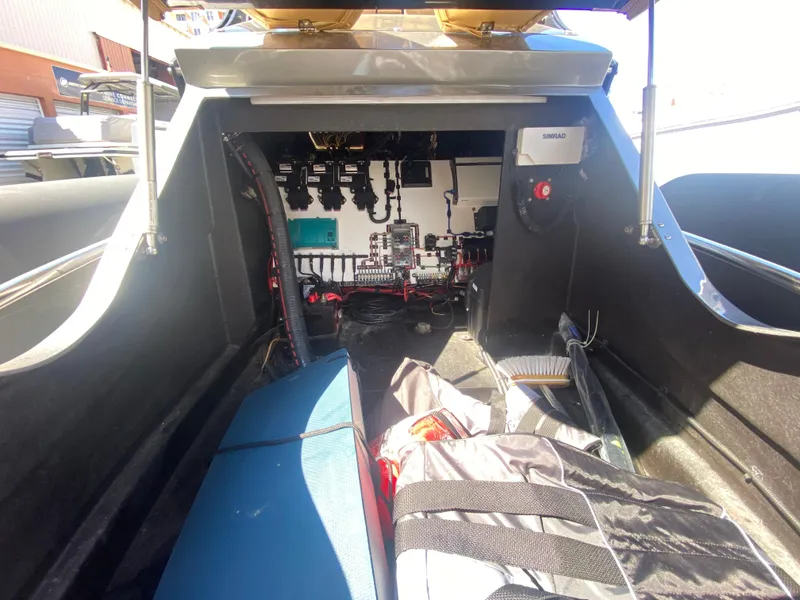Slide: The Image of Interior view of a 2018 Bernico RX10 boat, showcasing electronic components and storage area. - 21