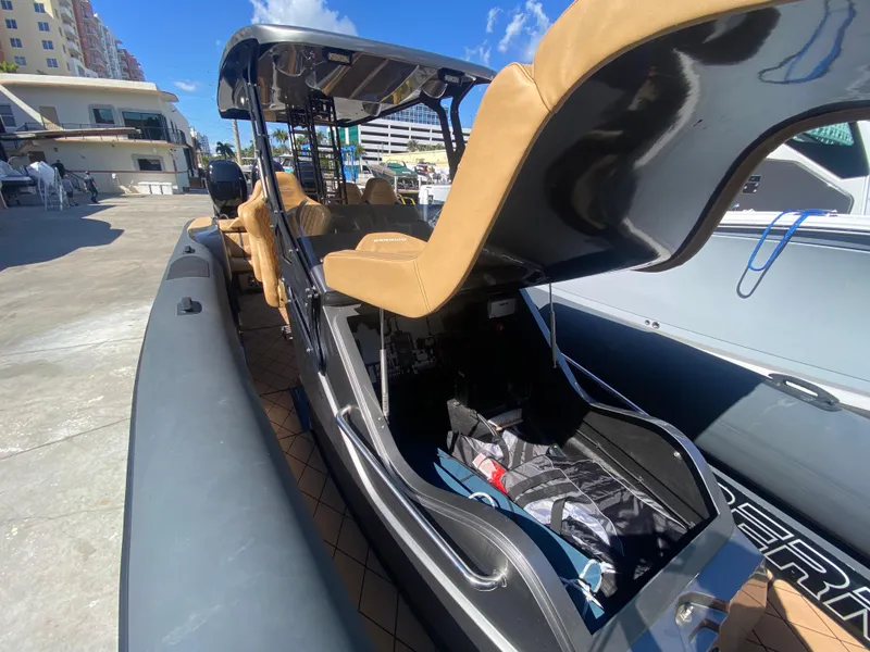 Slide: The Image of 2018 Bernico RX10 boat with tan seats docked under clear blue sky. - 22