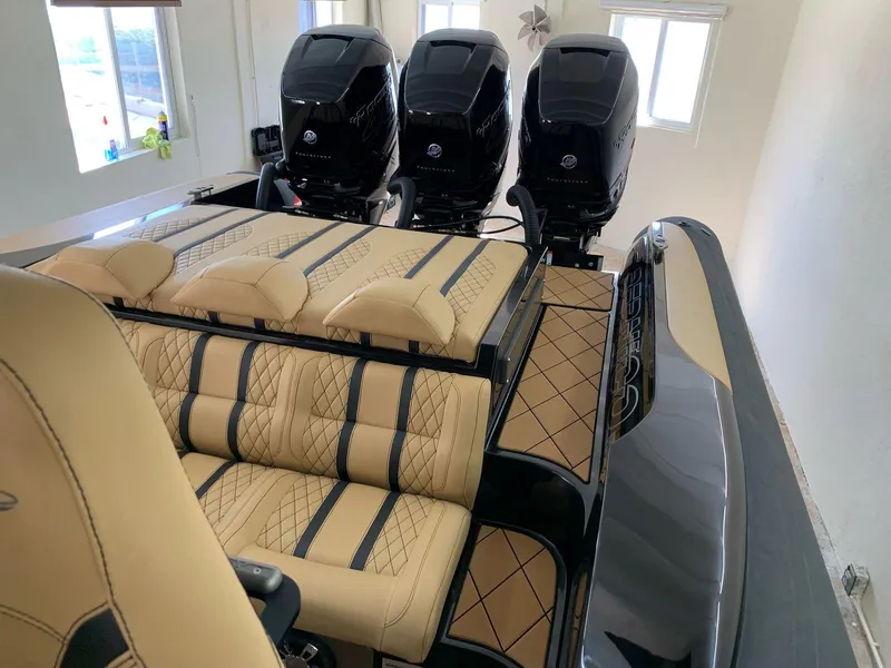 Slide: The Image of 2018 Bernico RX10 boat with luxurious seating and triple outboard engines. - 6