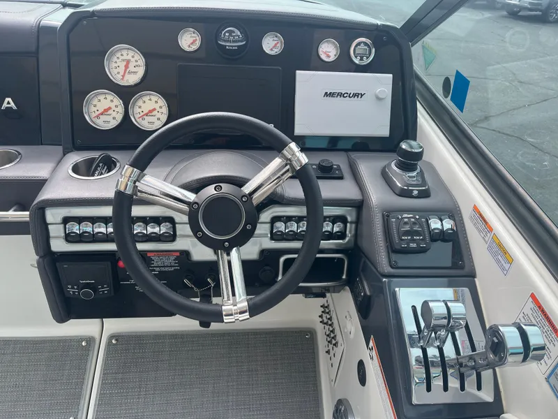 Slide: The Image of 2022 Formula 330 Crossover Bowrider I/O dashboard with steering wheel and controls. - 10