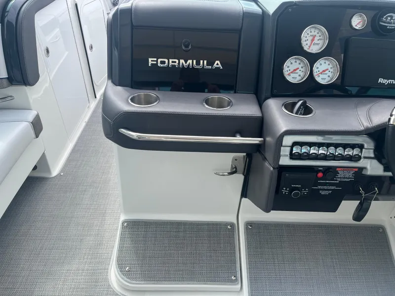 Slide: The Image of 2022 Formula 330 Crossover Bowrider I/O dashboard with gauges and controls. - 11