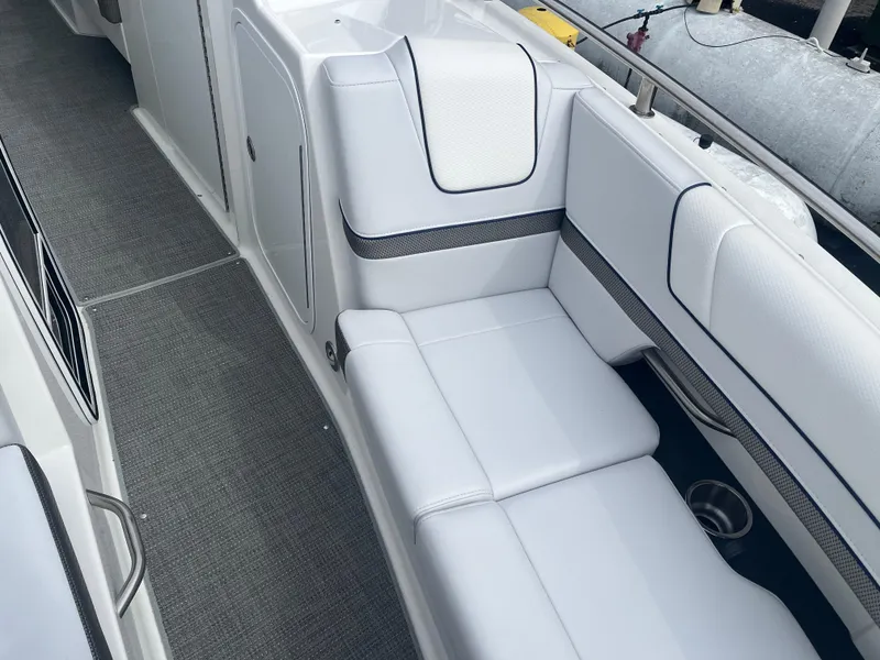 Slide: The Image of 2022 Formula 330 Crossover Bowrider I/O interior with sleek white seating and modern design. - 16