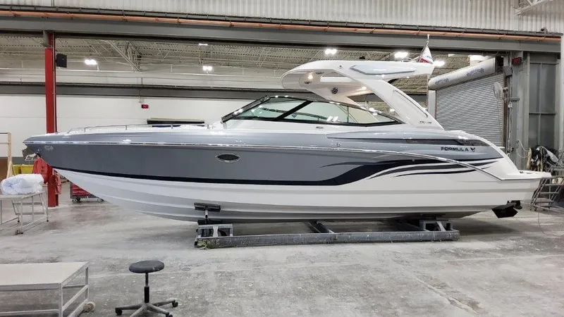 Slide: The Image of 2022 Formula 330 Crossover Bowrider I/O in a showroom, showcasing sleek design and modern features. - 18