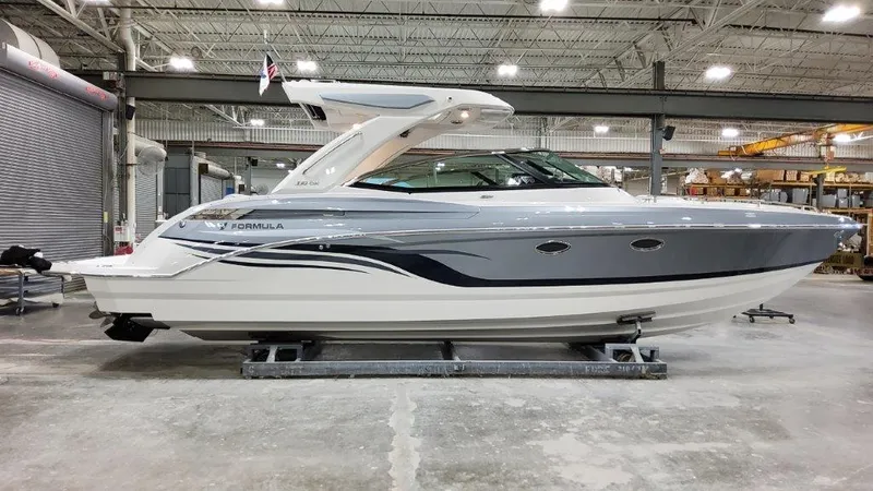 Slide: The Image of 2022 Formula 330 Crossover Bowrider I/O in a showroom, side view. - 22