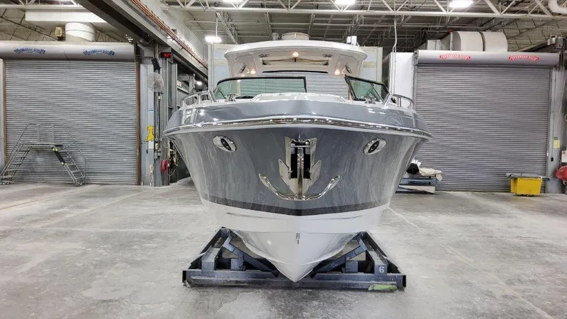 Slide: The Image of 2022 Formula 330 Crossover Bowrider I/O in a warehouse setting, front view. - 23