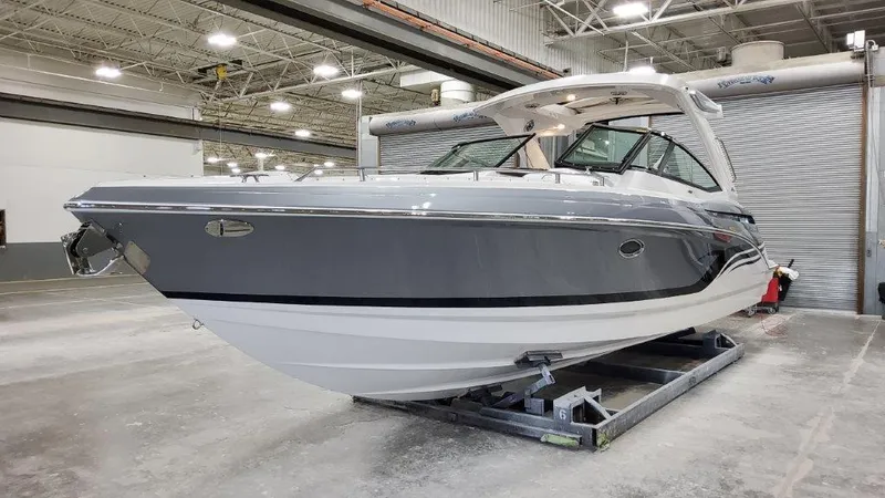 Slide: The Image of 2022 Formula 330 Crossover Bowrider I/O in a showroom, showcasing sleek design and modern features. - 24