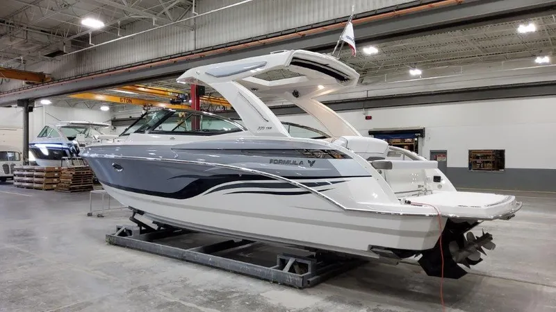 Slide: The Image of 2022 Formula 330 Crossover Bowrider I/O in a warehouse setting. - 25