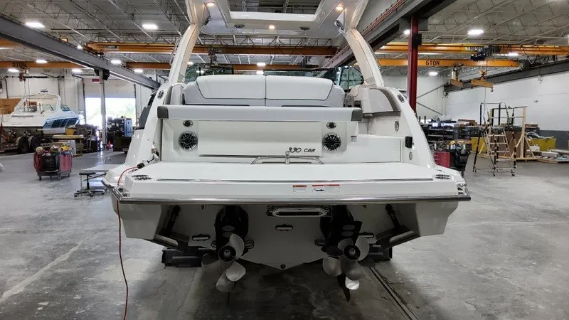 Slide: The Image of 2022 Formula 330 Crossover Bowrider I/O in a spacious indoor facility. - 26