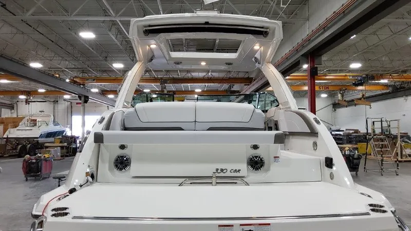 Slide: The Image of 2022 Formula 330 Crossover Bowrider I/O in a spacious indoor facility. - 27