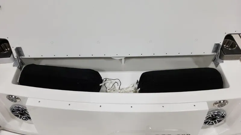 Slide: The Image of 2022 Formula 330 Crossover Bowrider I/O storage compartment with speakers and cushions. - 30