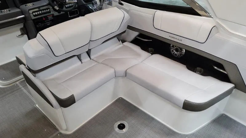 Slide: The Image of 2022 Formula 330 Crossover Bowrider I/O interior seating with luxurious white upholstery. - 40