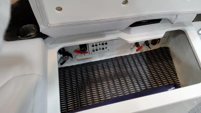 Slide: The Image of 2022 Formula 330 Crossover Bowrider I/O storage compartment with control panel and safety features. - 42