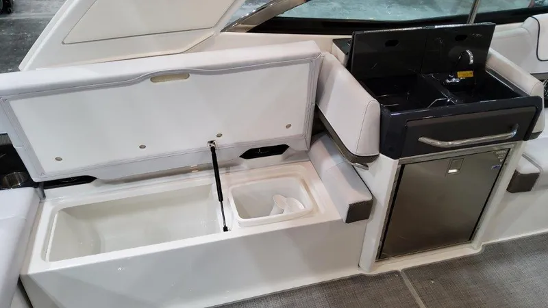 Slide: The Image of 2022 Formula 330 Crossover Bowrider I/O interior with storage and kitchenette features. - 44