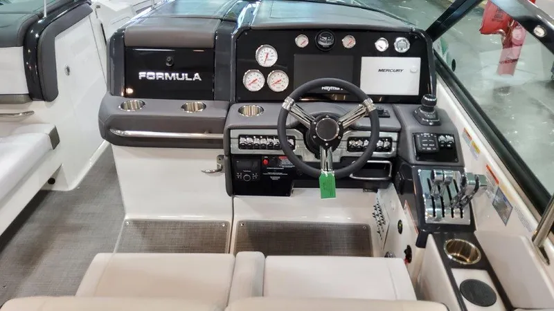 Slide: The Image of 2022 Formula 330 Crossover Bowrider I/O dashboard with steering wheel and control panel. - 49