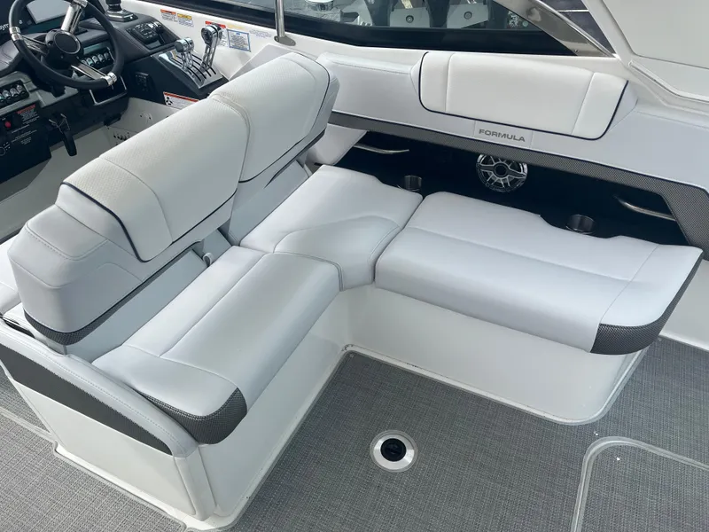 Slide: The Image of 2022 Formula 330 Crossover Bowrider I/O interior with luxurious white seating and modern controls. - 6