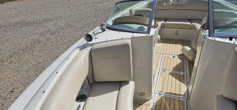 Slide: The Image of 2007 Chris-Craft Launch 22 boat interior with beige seating and wooden flooring. - 11