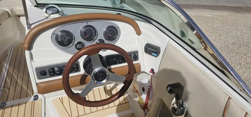 Slide: The Image of 2007 Chris-Craft Launch 22 boat dashboard with steering wheel and control panel. - 12
