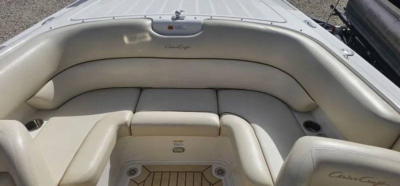 Slide: The Image of 2007 Chris-Craft Launch 22 boat interior with cream leather seating and wood accents. - 14