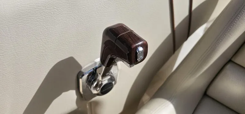 Slide: The Image of 2007 Chris-Craft Launch 22 throttle lever, featuring a sleek wooden handle design. - 16