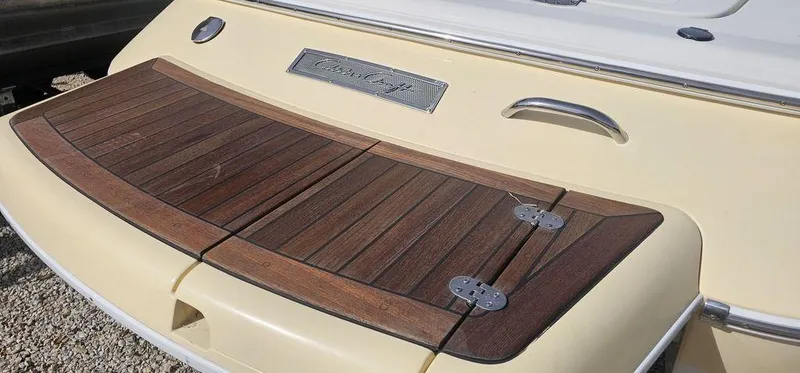 Slide: The Image of 2007 Chris-Craft Launch 22 boat with wooden swim platform and beige exterior. - 22