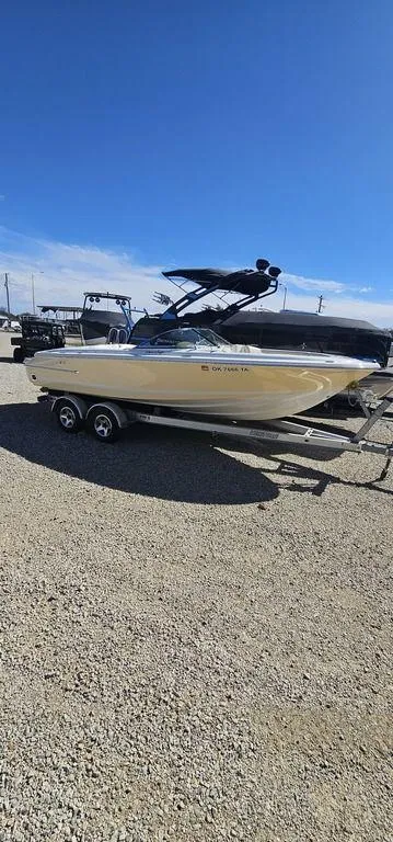 Slide: The Image of 2007 Chris-Craft Launch 22 boat on trailer under clear blue sky. - 3