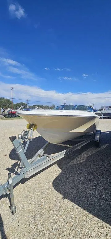 Slide: The Image of 2007 Chris-Craft Launch 22 boat on trailer under clear blue sky. - 4