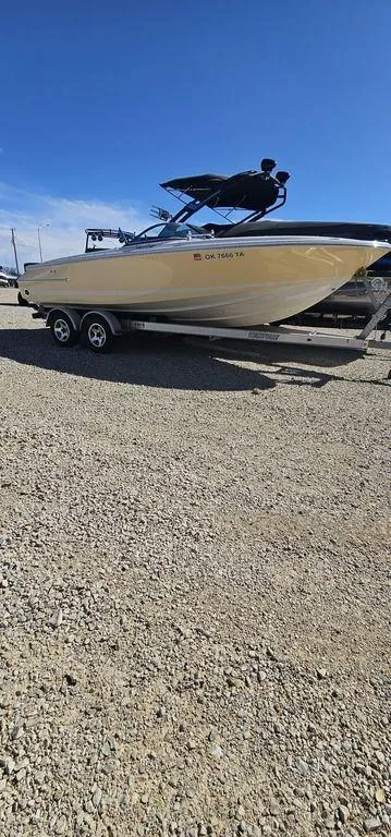 Slide: The Image of 2007 Chris-Craft Launch 22 boat on trailer under clear blue sky. - 5