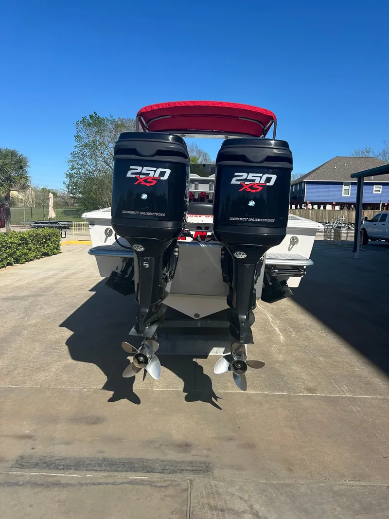 Slide: The Image of 2009 Concept 30 SD boat with twin 250 HP outboard motors, parked on a driveway. - 12