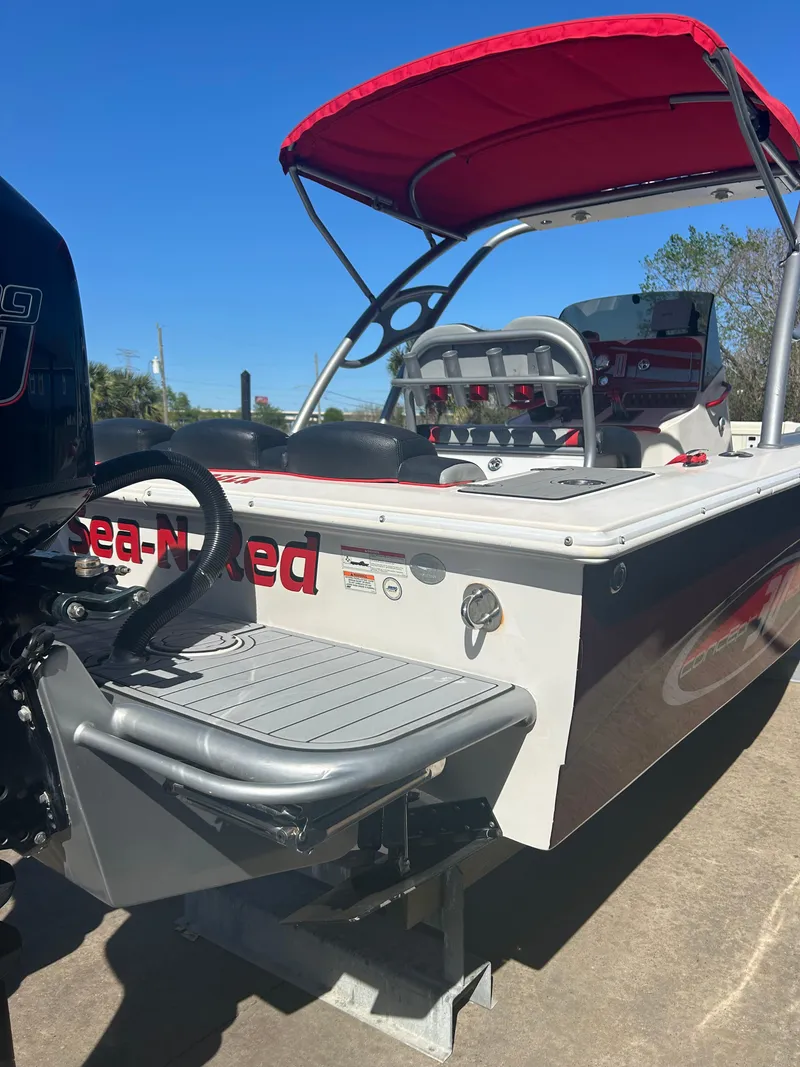 Slide: The Image of 2009 Concept 30 SD boat with red canopy and outboard motor, docked under clear blue sky. - 14