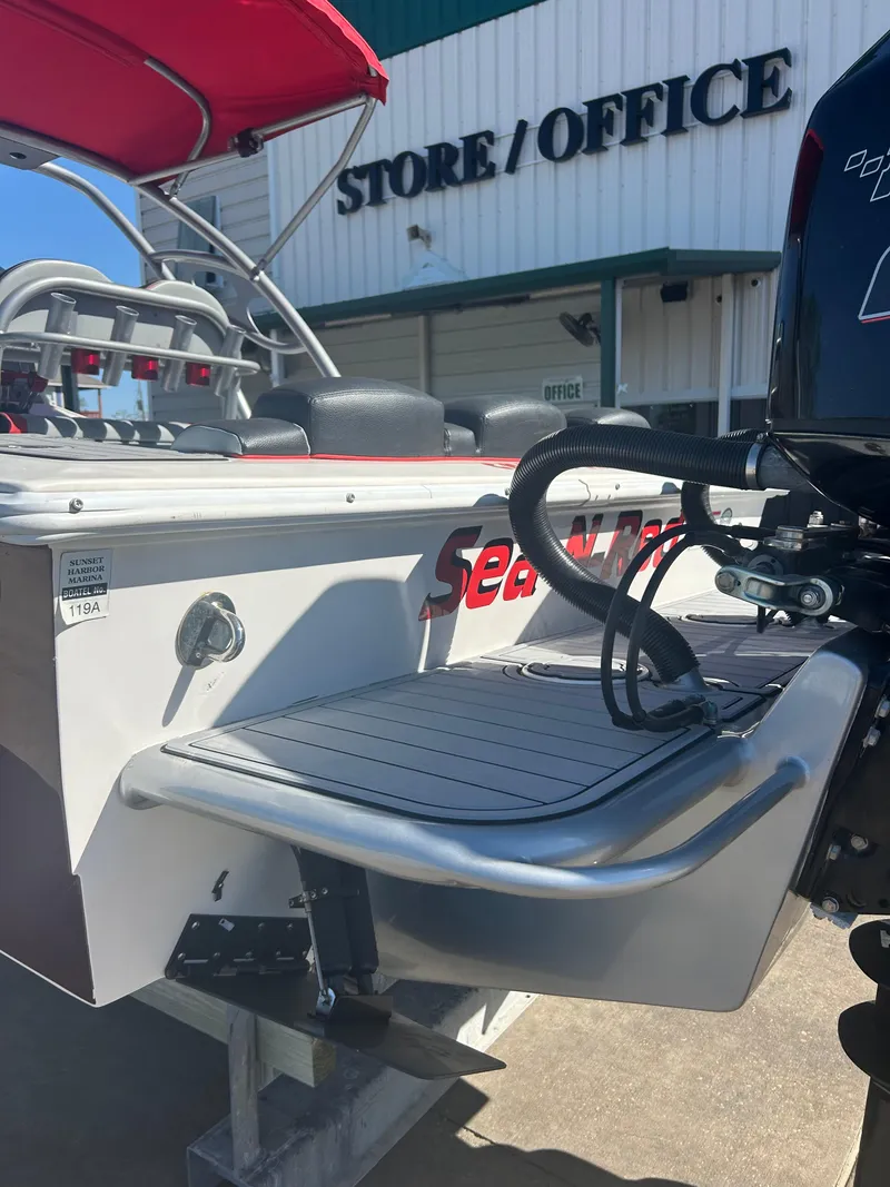 Slide: The Image of 2009 Concept 30 SD boat near store, featuring rear deck and outboard motor. - 16