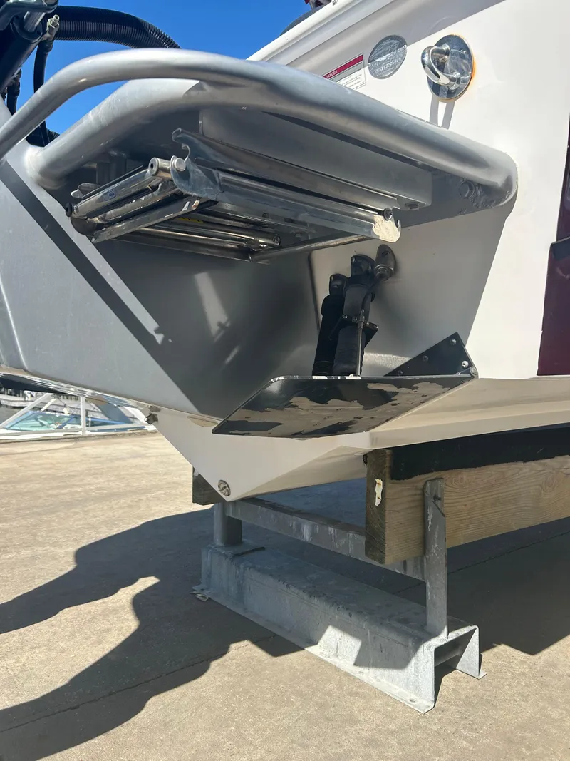 Slide: The Image of 2009 Concept 30 SD boat with a metal swim ladder and platform on a dock. - 18