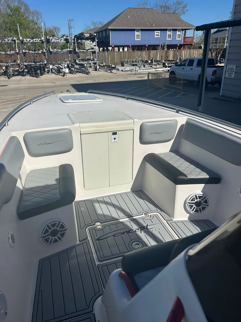 Slide: The Image of 2009 Concept 30 SD boat interior with seating and storage, docked at a marina. - 33