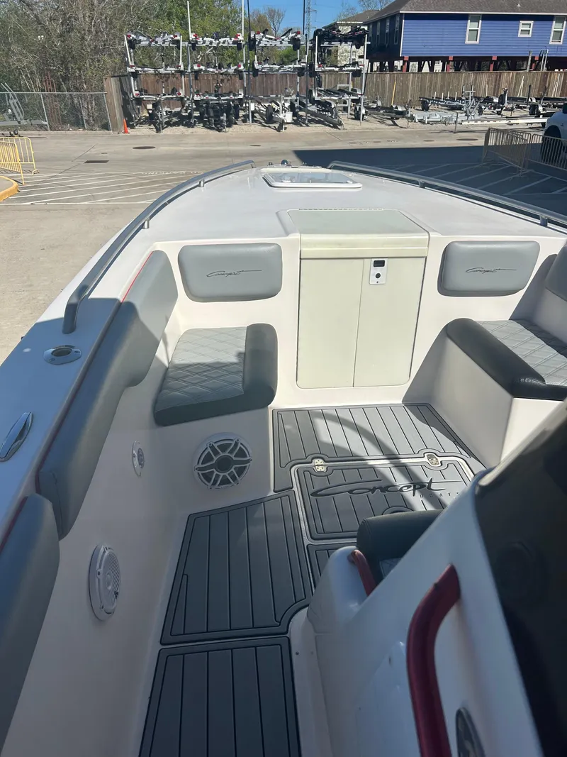 Slide: The Image of 2009 Concept 30 SD boat interior with seating and storage, docked outdoors. - 35