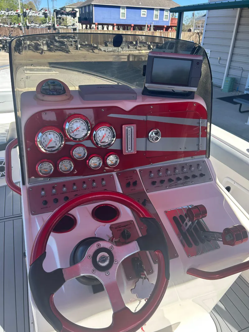 Slide: The Image of Control panel of a 2009 Concept 30 SD boat with red accents and gauges. - 42