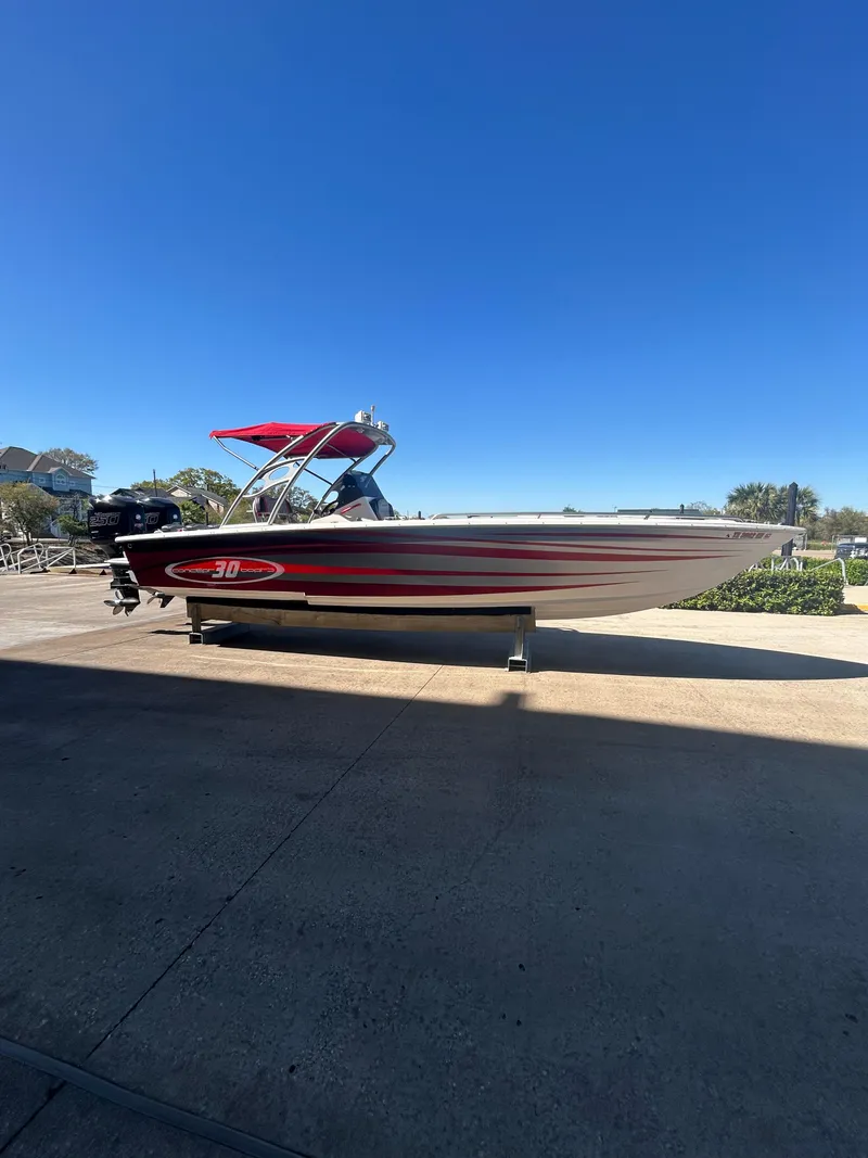 Slide: The Image of 2009 Concept 30 SD boat with red accents on a sunny day. - 6