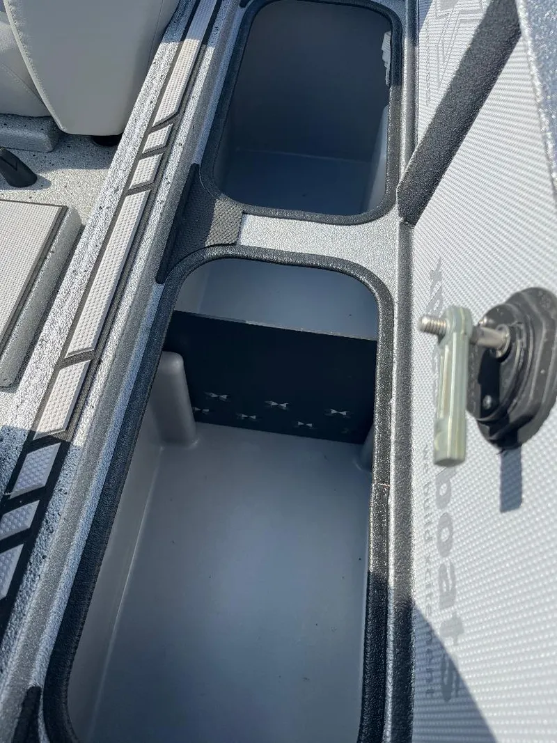 Slide: The Image of Open storage compartment in a 2022 Xpress X19 Pro boat. - 10