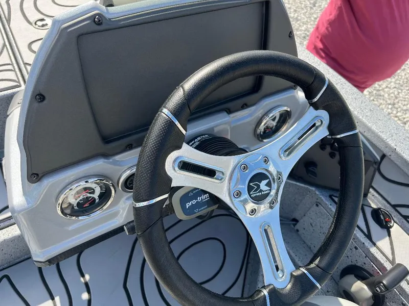 Slide: The Image of Steering wheel of 2022 Xpress X19 Pro boat with dashboard controls. - 12