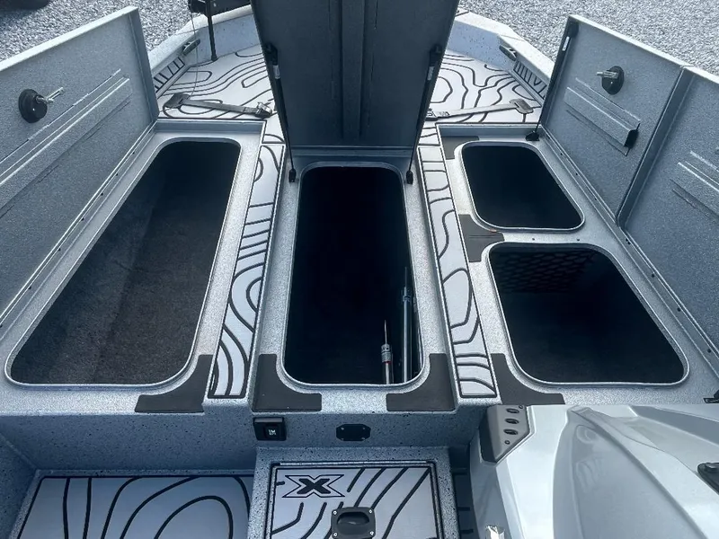 Slide: The Image of 2022 Xpress X19 Pro boat storage compartments with open lids, showcasing spacious interior design. - 14