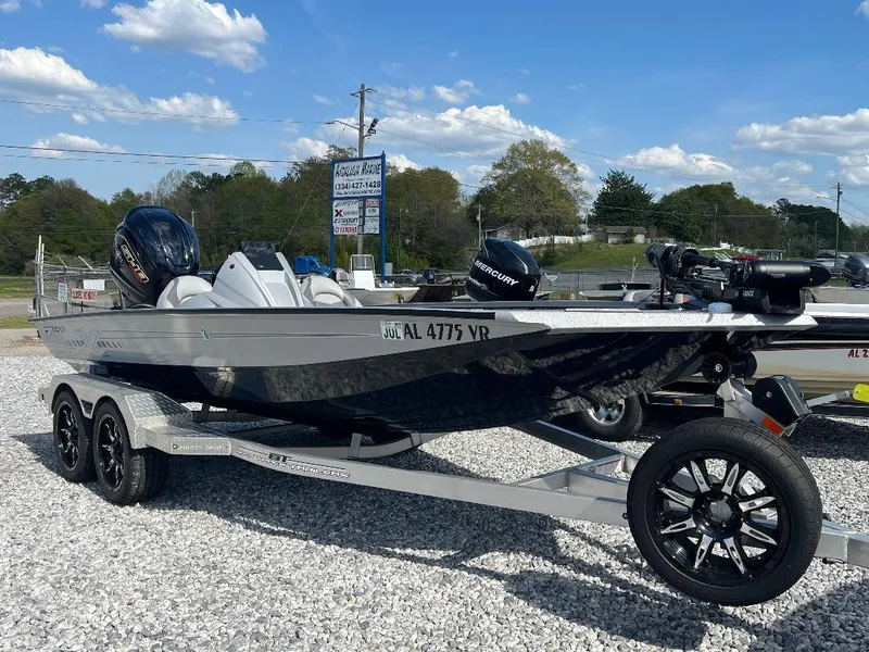 Slide: The Image of 2022 Xpress X19 Pro boat on trailer, parked on gravel, under a clear blue sky. - 4