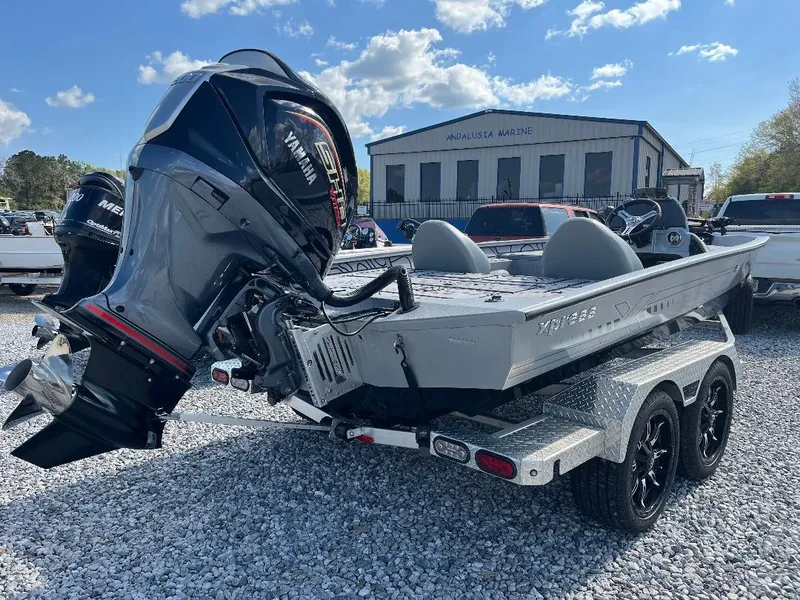 Slide: The Image of 2022 Xpress X19 Pro boat on trailer with Yamaha outboard motor, parked on gravel. - 6