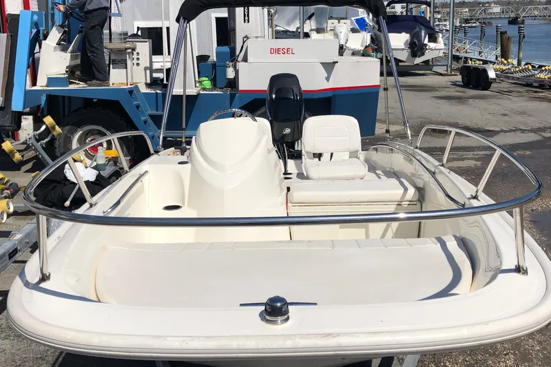Slide: The Image of 2013 Boston Whaler 150 Super Sport boat docked at a marina. - 18