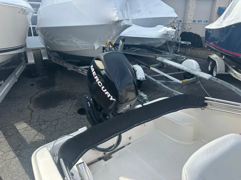 Slide: The Image of 2013 Boston Whaler 150 Super Sport with Mercury outboard motor in a boatyard. - 19