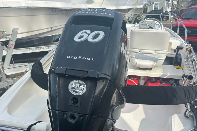 Slide: The Image of 2013 Boston Whaler 150 Super Sport with 60 HP BigFoot engine, docked. - 22