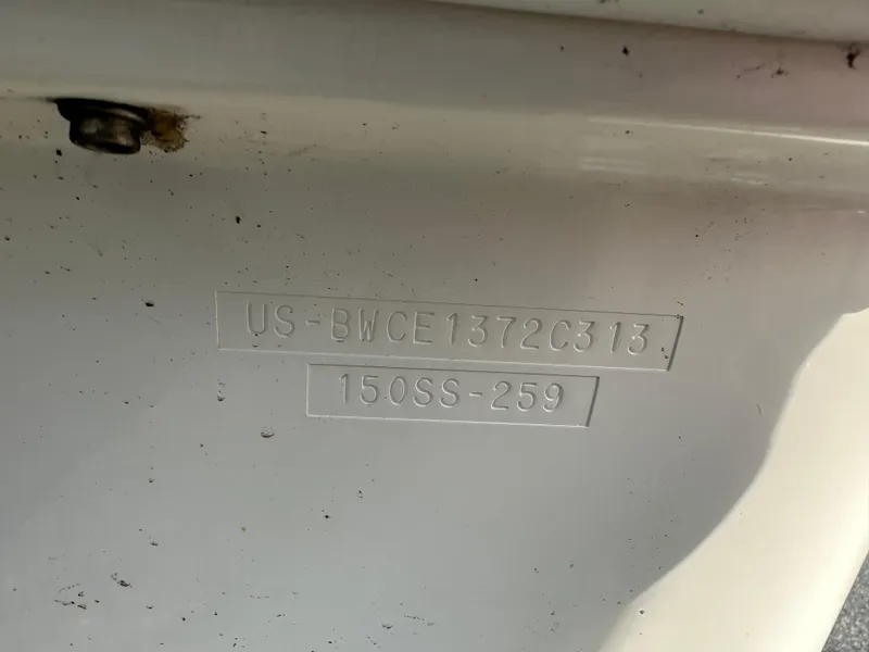 Slide: The Image of 2013 Boston Whaler 150 Super Sport hull identification number on white surface. - 24