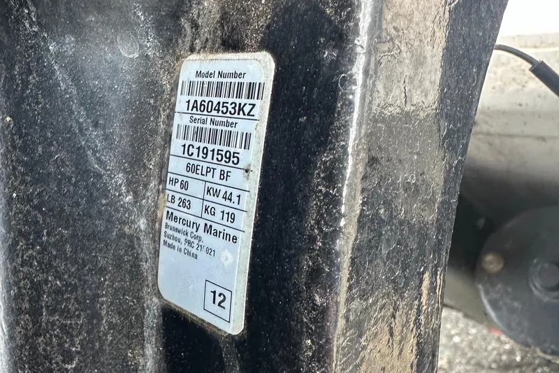 Slide: The Image of Label on a 2013 Boston Whaler 150 Super Sport, featuring Mercury Marine engine details. - 25