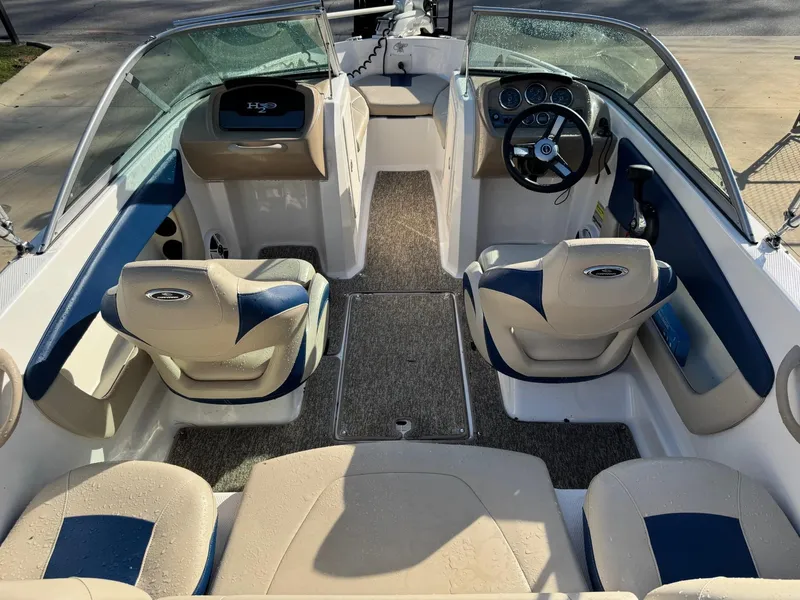Slide: The Image of 2017 Chaparral 18 H20 Ski & Fish boat interior with beige and blue seating, steering wheel, and dashboard. - 4