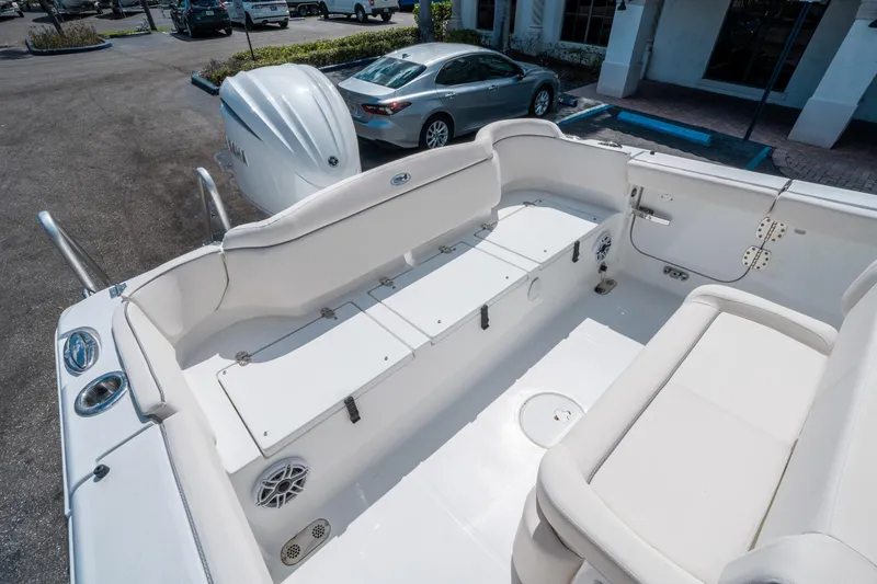 Slide: The Image of 2025 Sea Hunt Ultra 255 SE boat interior with white seating and storage compartments. - 13