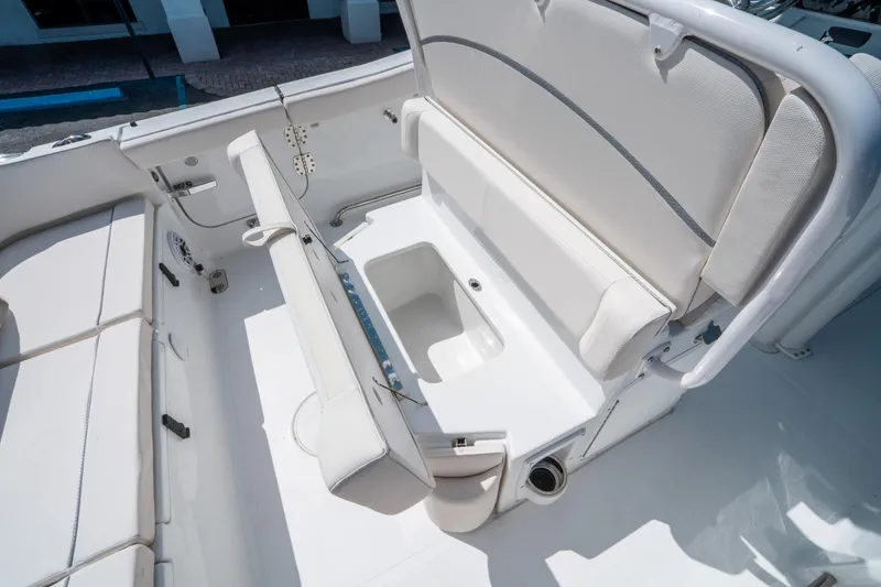 Slide: The Image of 2025 Sea Hunt Ultra 255 SE boat interior with foldable seating and storage compartment. - 17