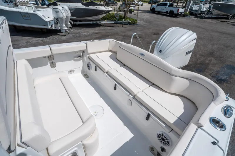 Slide: The Image of 2025 Sea Hunt Ultra 255 SE boat interior with white seating and Yamaha engine. - 12
