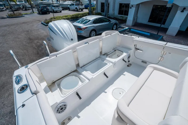 Slide: The Image of 2025 Sea Hunt Ultra 255 SE boat interior with open storage compartments and seating. - 14